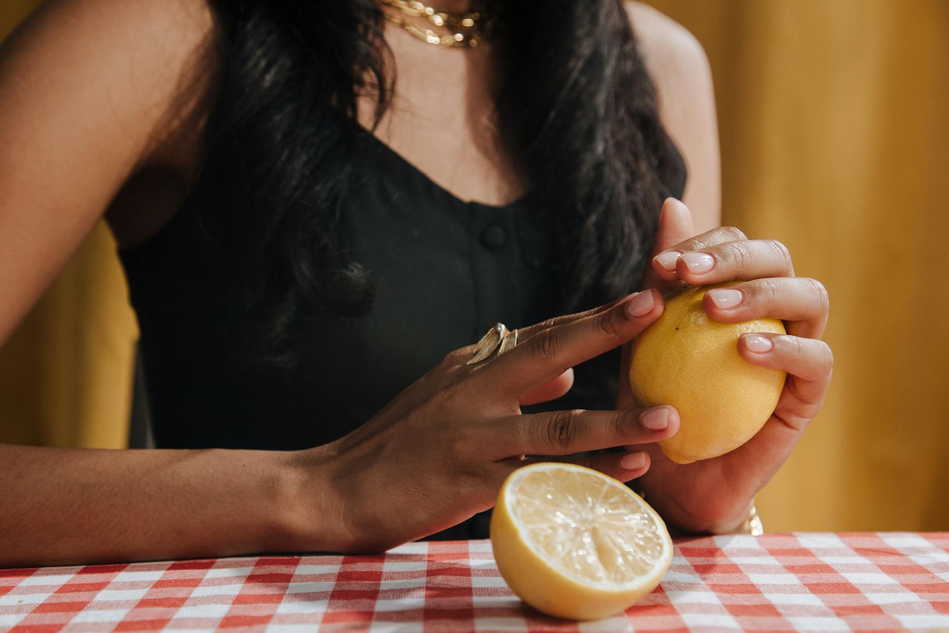 A woman holding a fresh lemon, symbolizing renewal and self-care after a relationship transition.