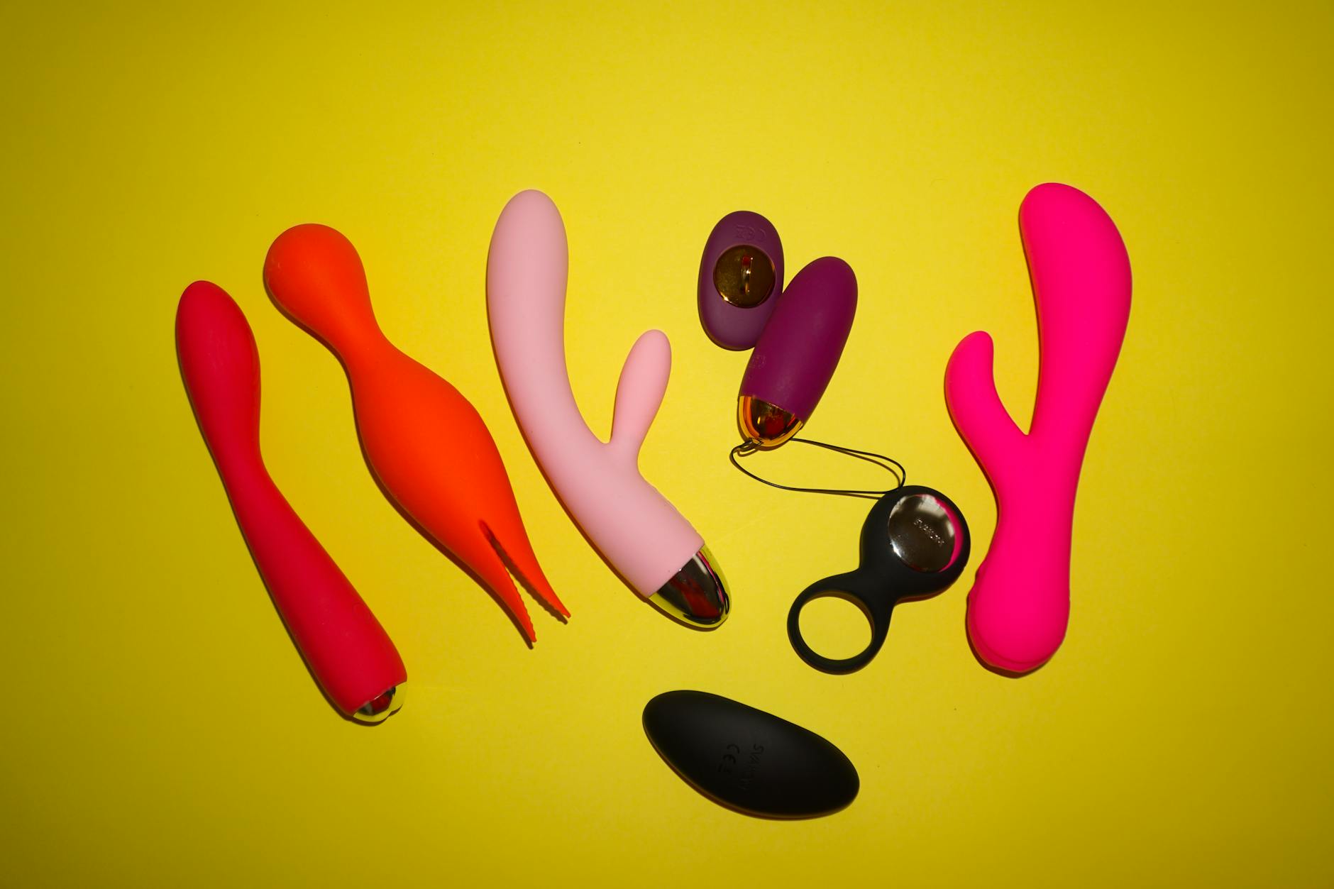 Array of vibrators in various colors on a yellow background